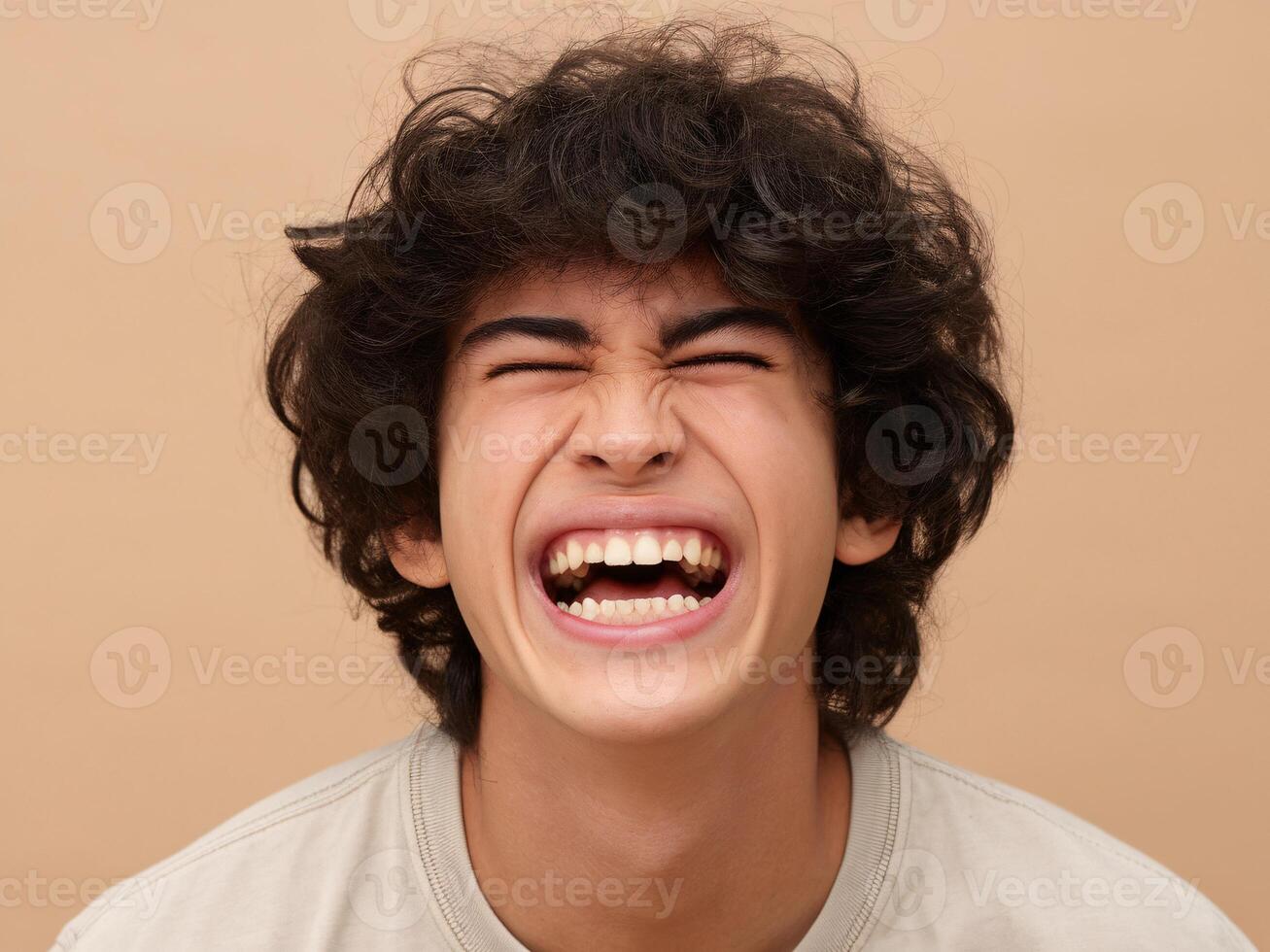 A young man with curly hair is making a funny face photo