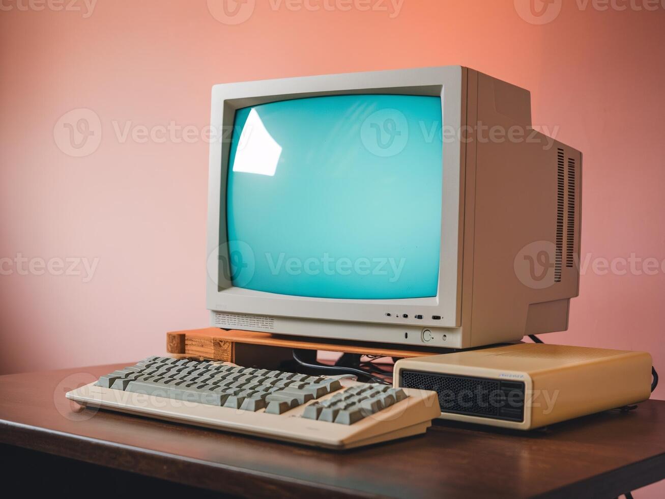 Retro computer setup featuring a vintage monitor and keyboard against a pastel background. photo