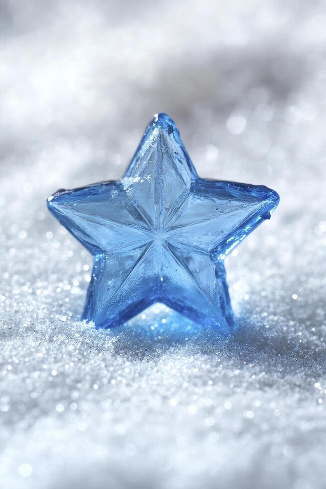 A blue star shaped crystal on a snow covered surface photo