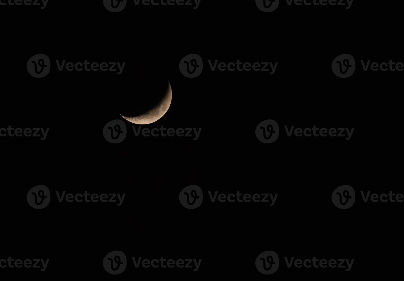 Crescent against dark night sky background with space for Ramadan, Isolated new moon rising or waxing crescent on black background concept for symbolizes of growth, hope photo