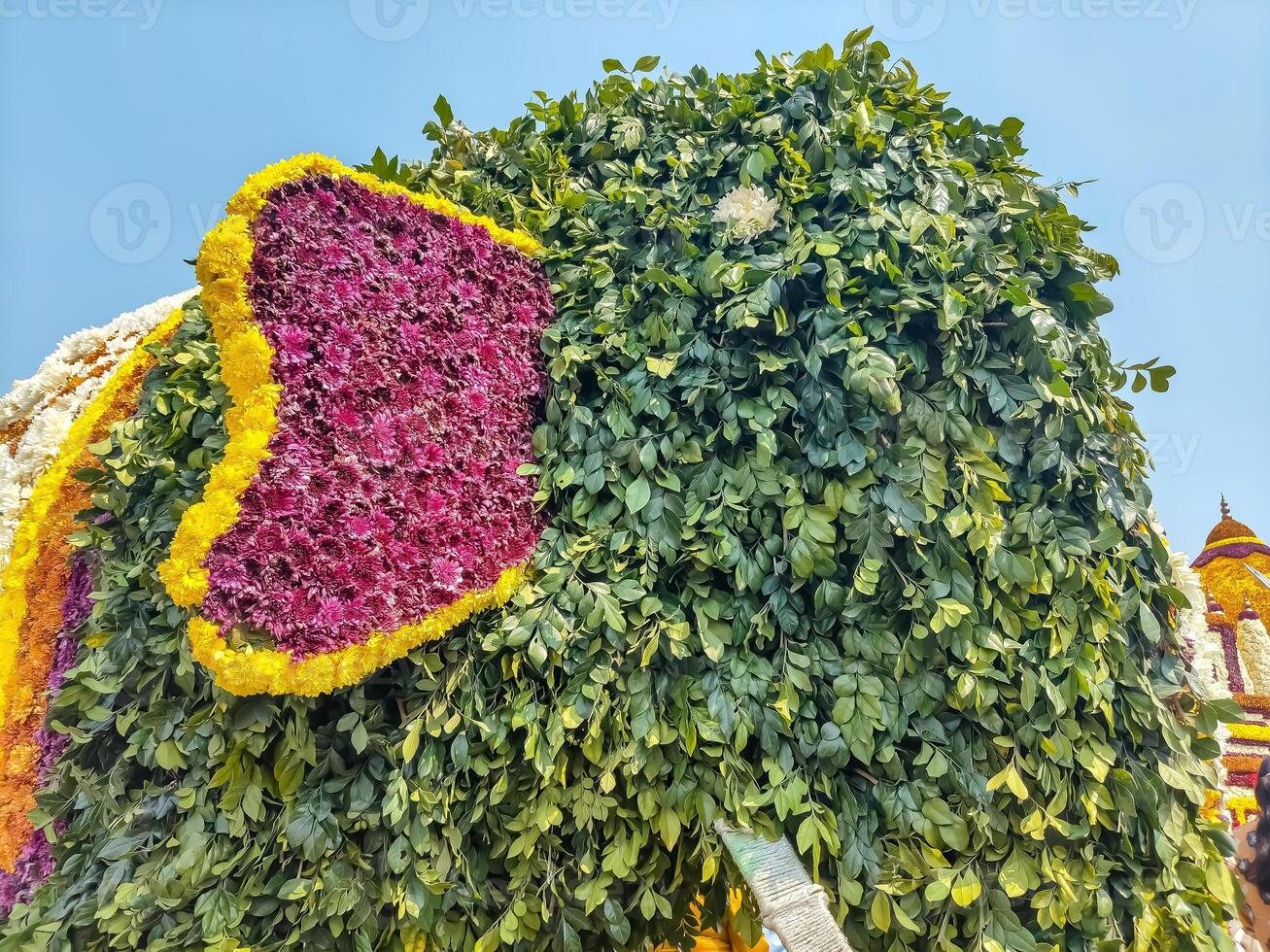 A large elephant made of flowers and leaves photo