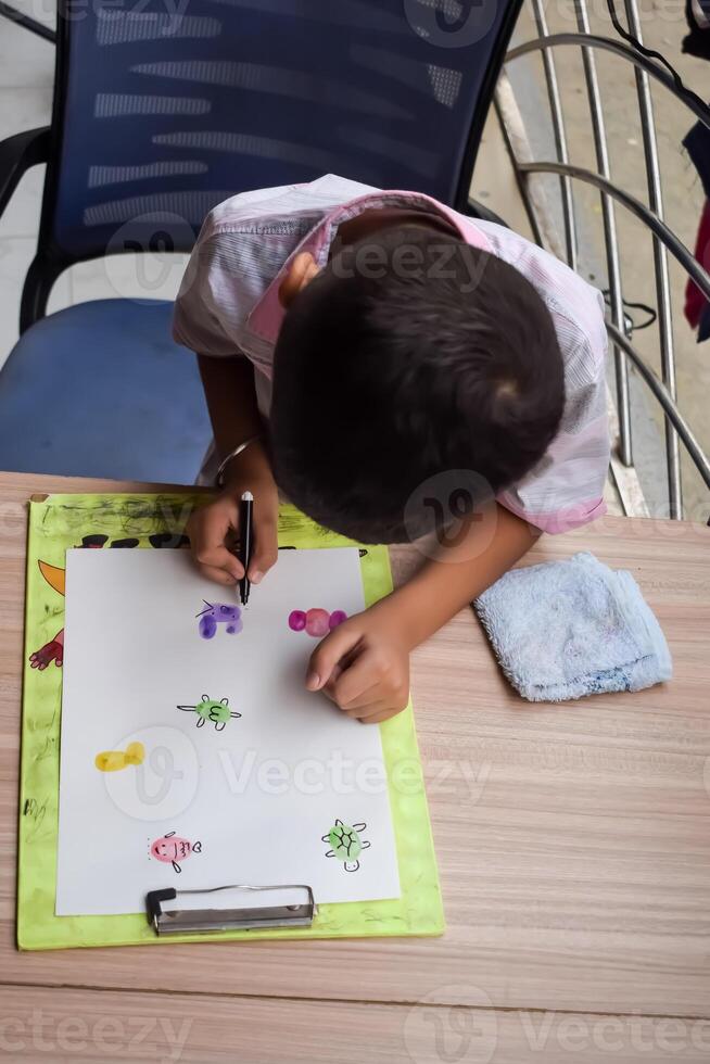 A child drawing on a piece of paper photo