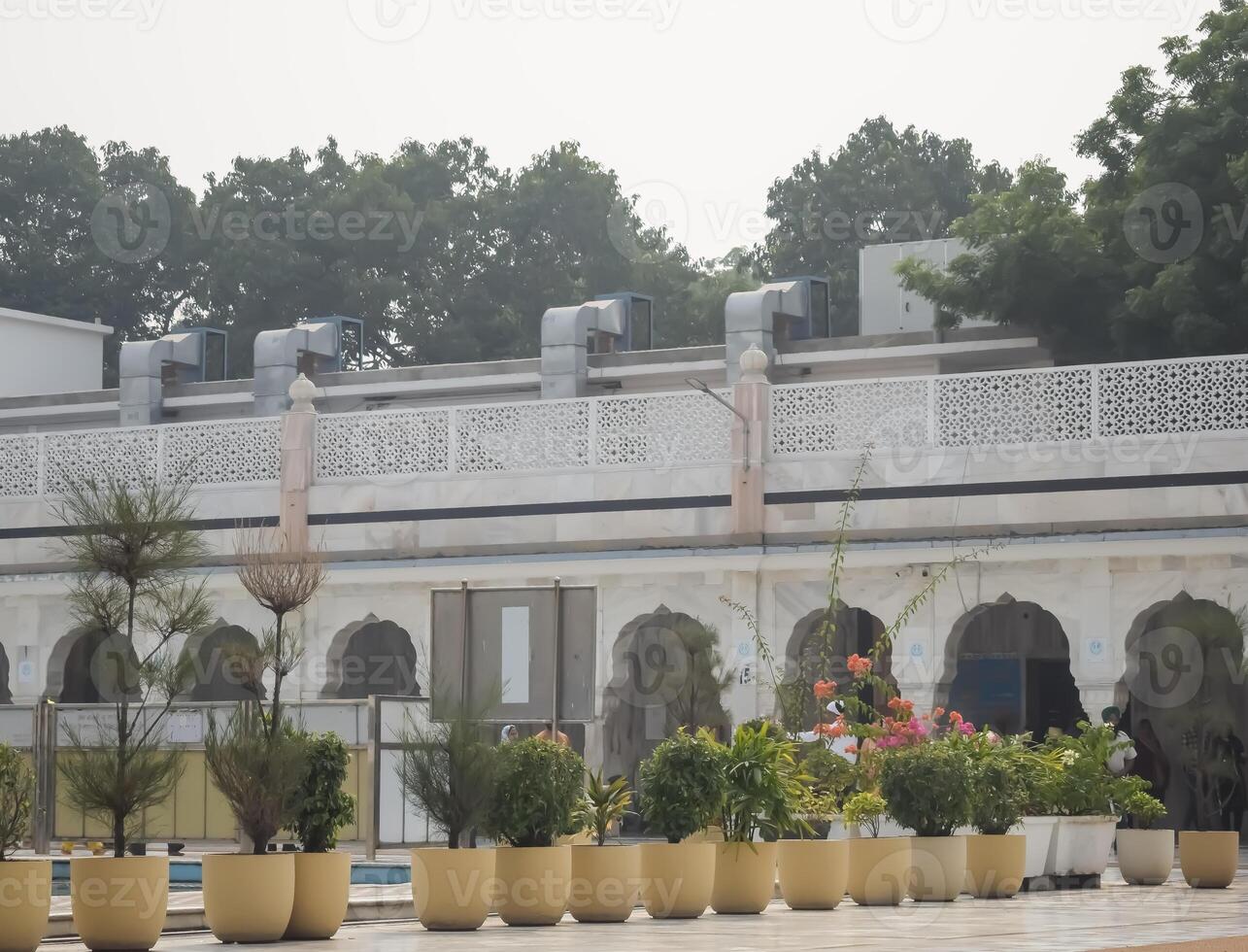 A large building with many potted plants in front of it photo