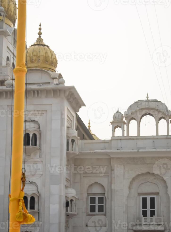 A yellow pole with a sign photo