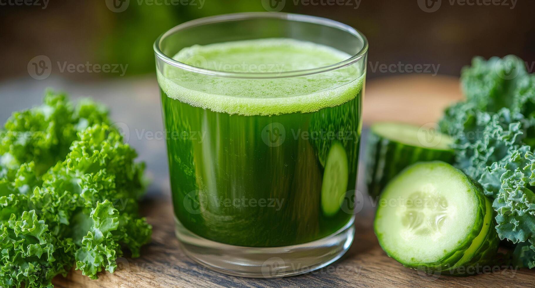 Glass of green vegetable smoothie made with kale and cucumber promoting healthy lifestyle photo