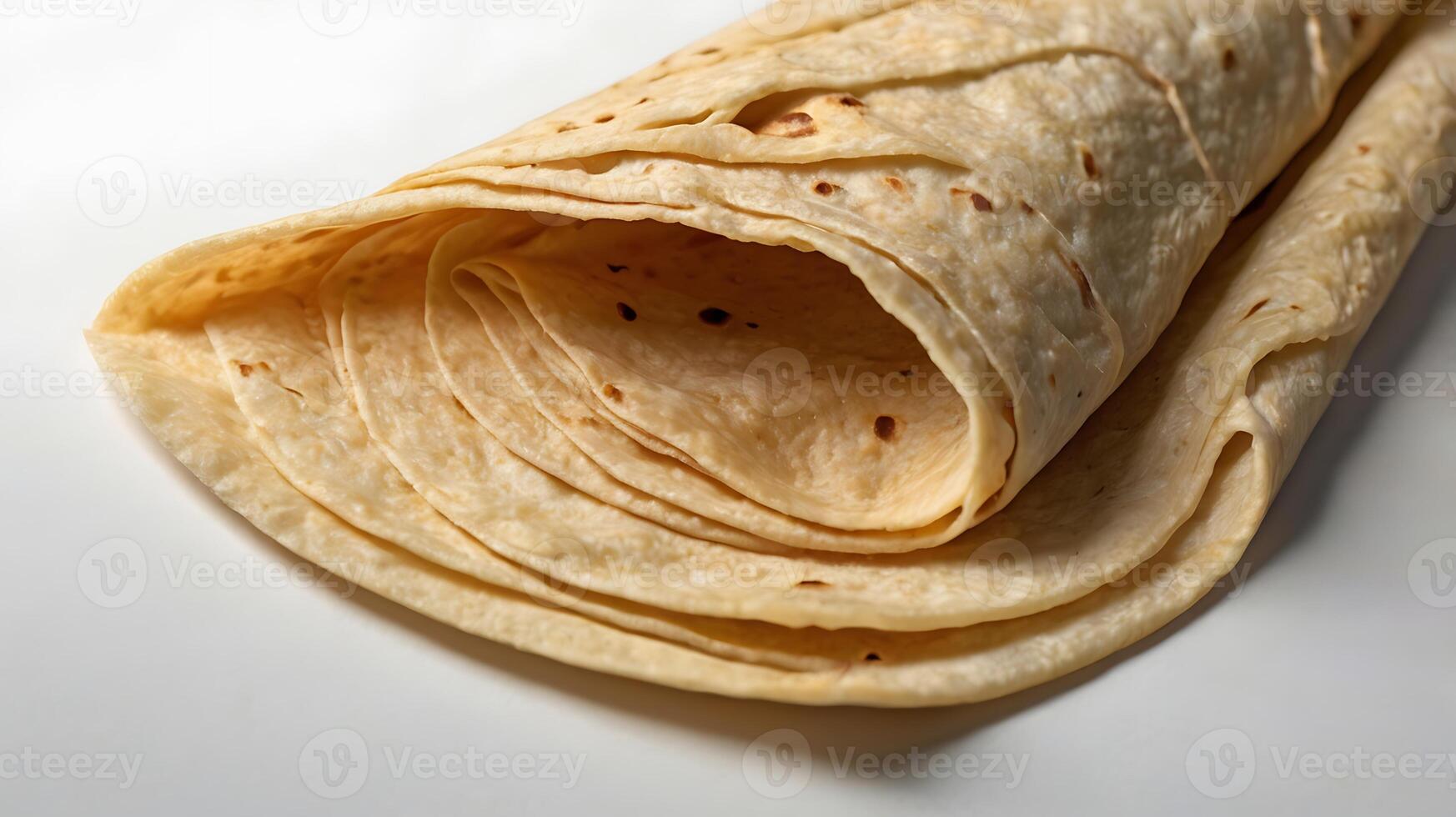 Closeup view of a folded tortilla showcasing its texture and layers photo