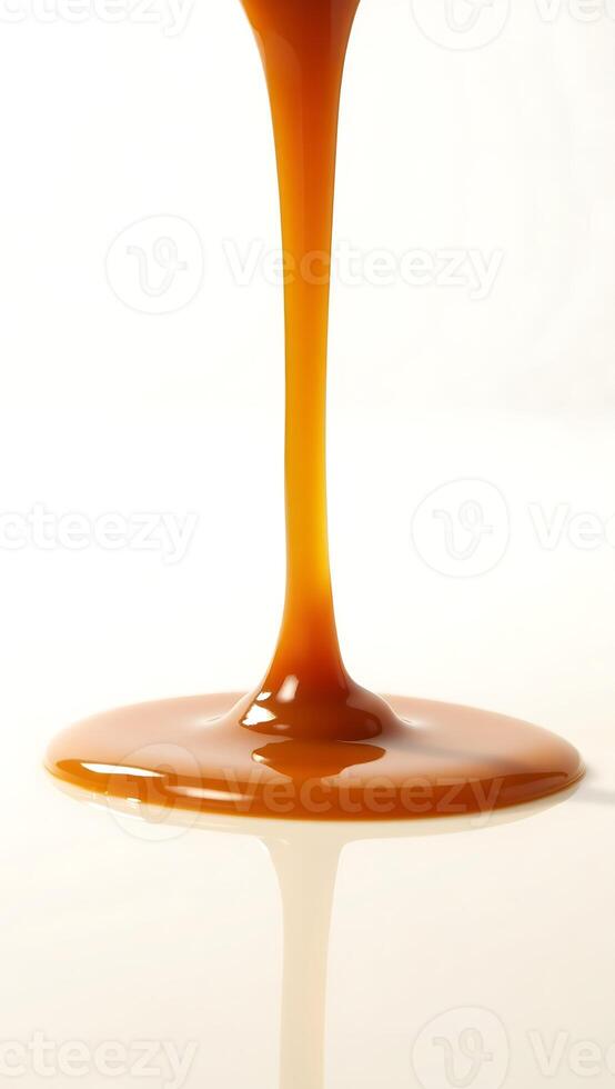 Closeup view of thick syrup cascading and pooling on a smooth surface photo