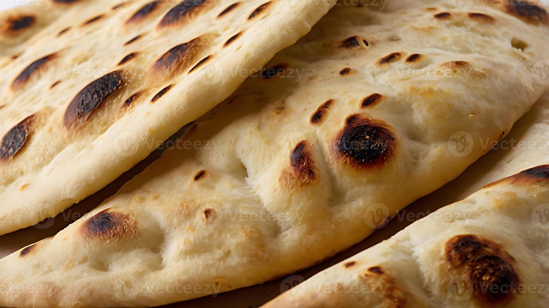 Closeup view of freshly baked naan bread highlighting its texture and flavor photo