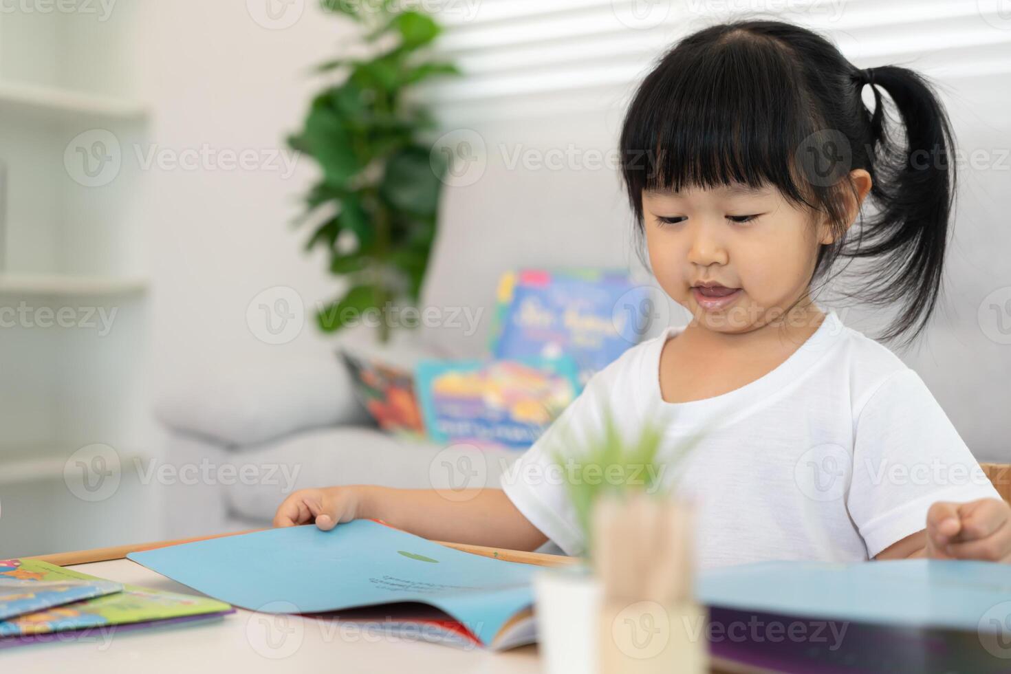 Happy Asian children relax read book at home. daughter and reading a story. learn development, childcare, laughing, education, storytelling, practice, imagine. photo