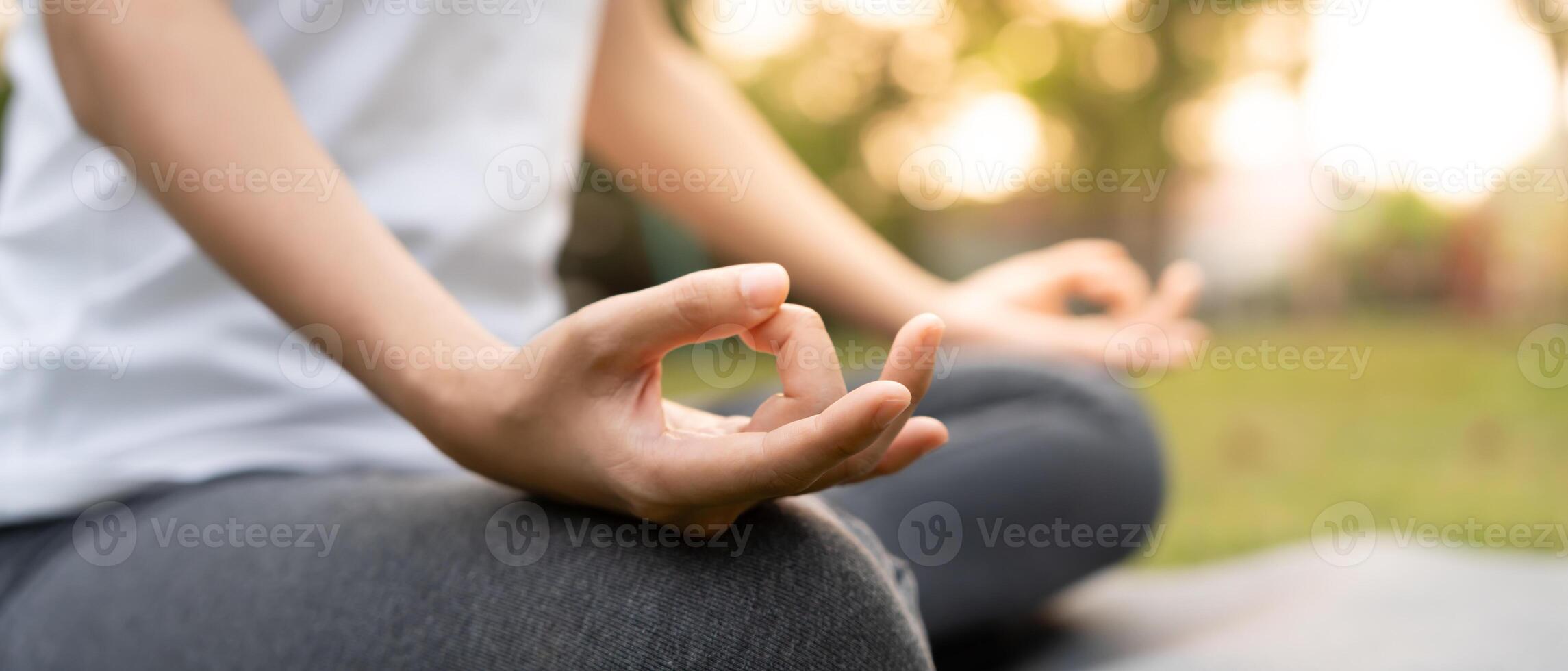practicing meditate on the park. Asian woman doing exercises in morning. balance, recreation, relaxation, calm, good health, happy, relax, healthy lifestyle, reduce stress, peaceful, Attitude. photo