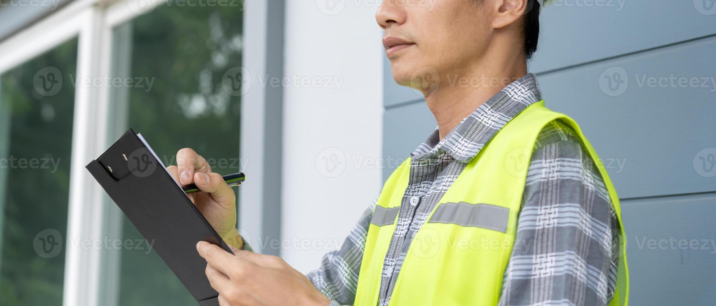 inspector or engineer is inspecting construction and quality assurance new house using a checklist. Engineers or architects or contactor work to build the house photo