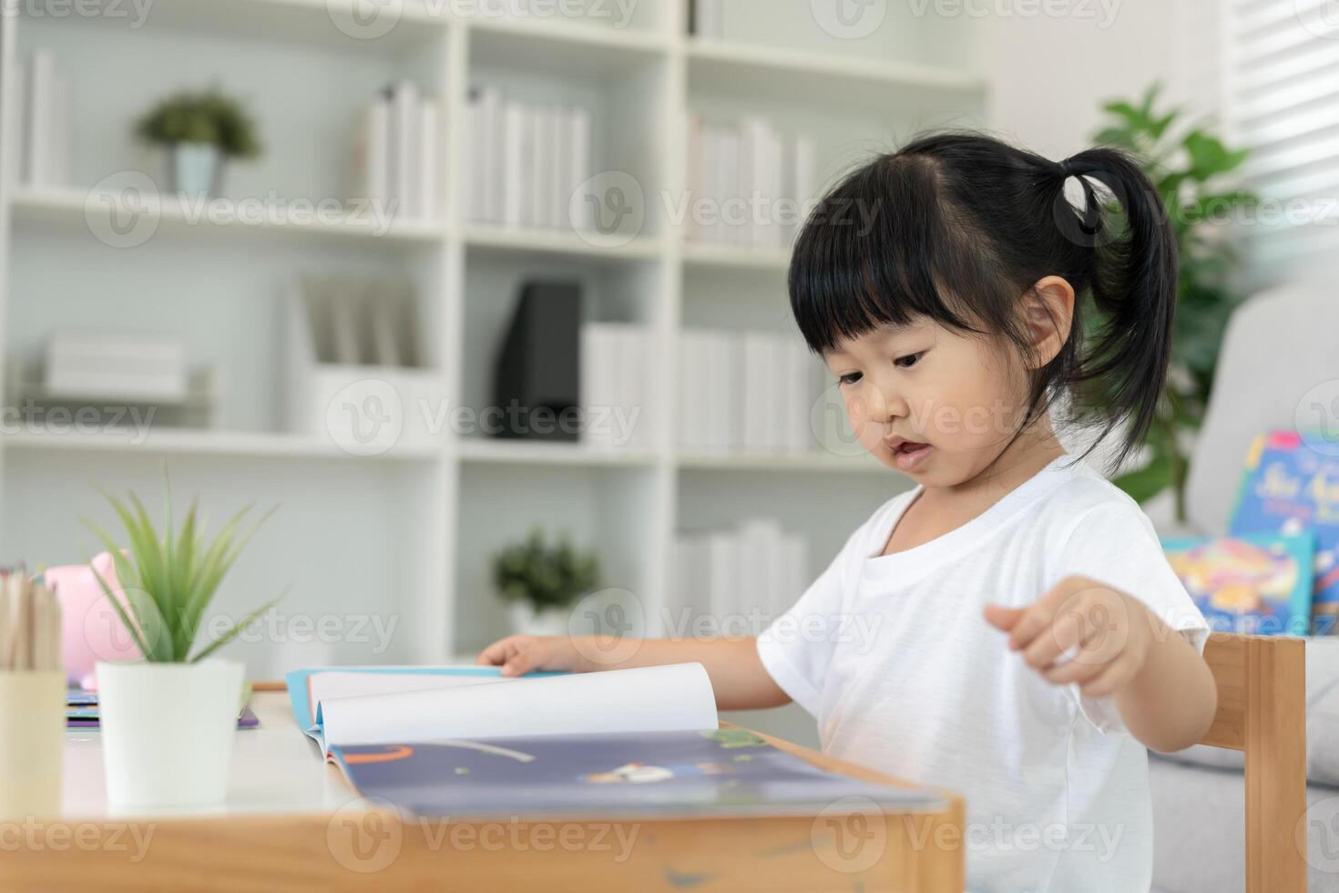 Asian children relax read book at home. daughter and reading a story. learn development, childcare, laughing, education, storytelling, practice, imagine. photo