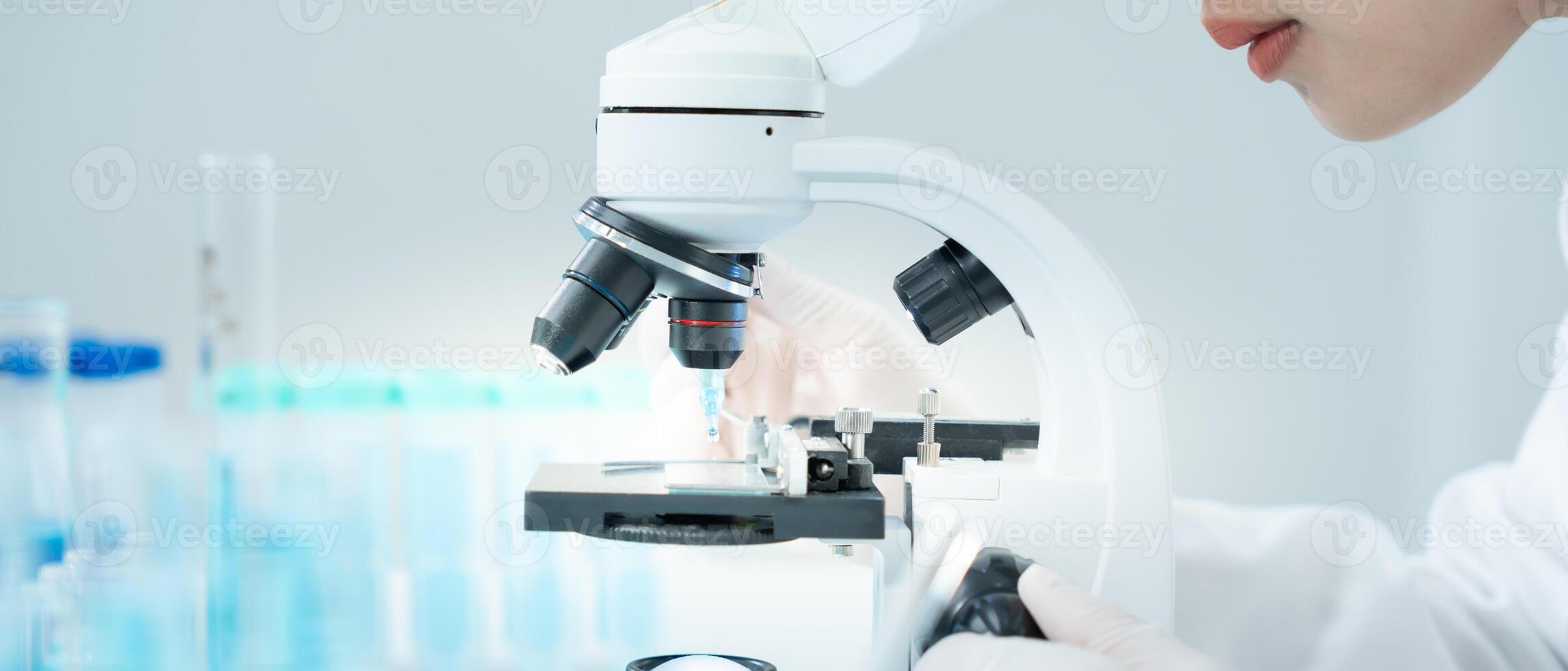 Scientist. analyze biochemical samples in advanced scientific laboratory. Medical professional use microscope look microbiological developmental of viral. Biotechnology research in science lab. photo
