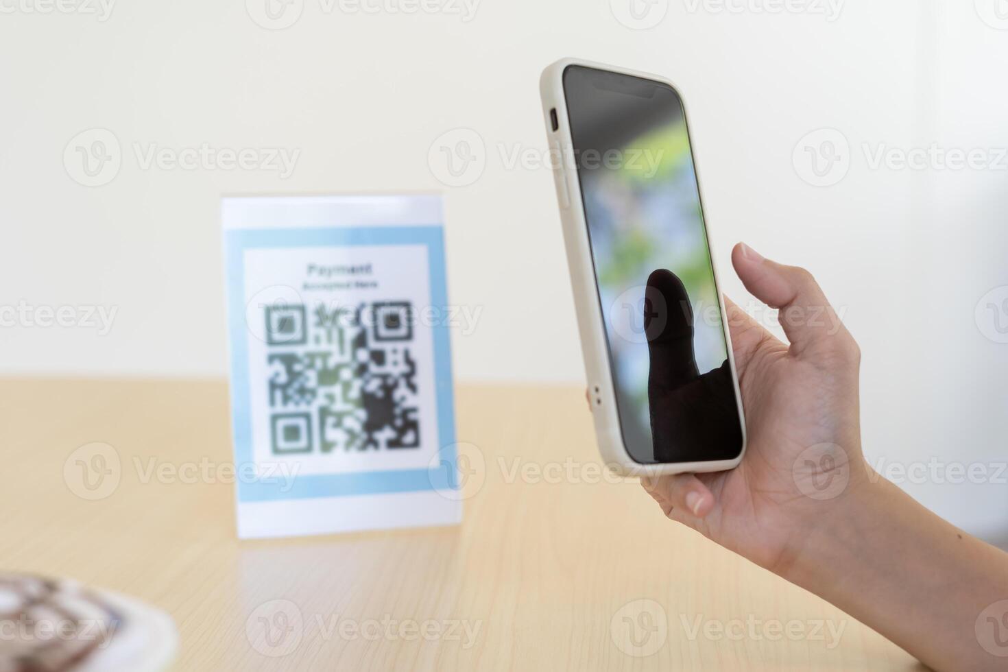Woman use smartphone to scan QR code for order menu in cafe restaurant with a digital delivery. Choose menu and order accumulate discount. E wallet, technology, pay online credit card photo