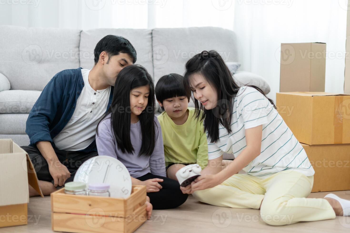 Moving house relocation. Family smile and play together after move to new home, inside the room was a cardboard box contain personal belongings and furniture. move in the new apartment, condominium photo