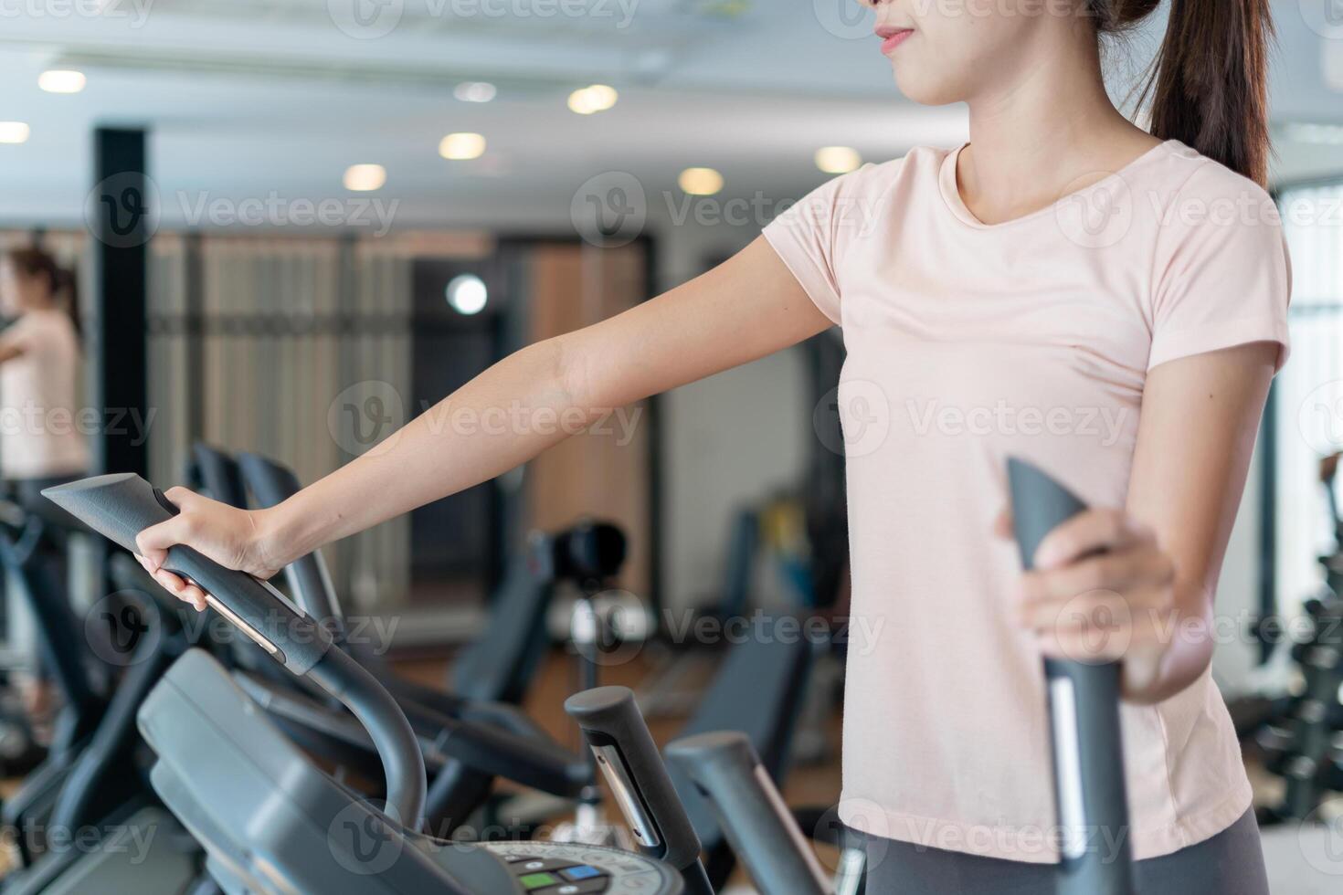 woman use Elliptical. exercisers and are checking how to exercise properly. correct exercise. diet, body shape, healthy, strong, care, gym, fitness, vacation photo