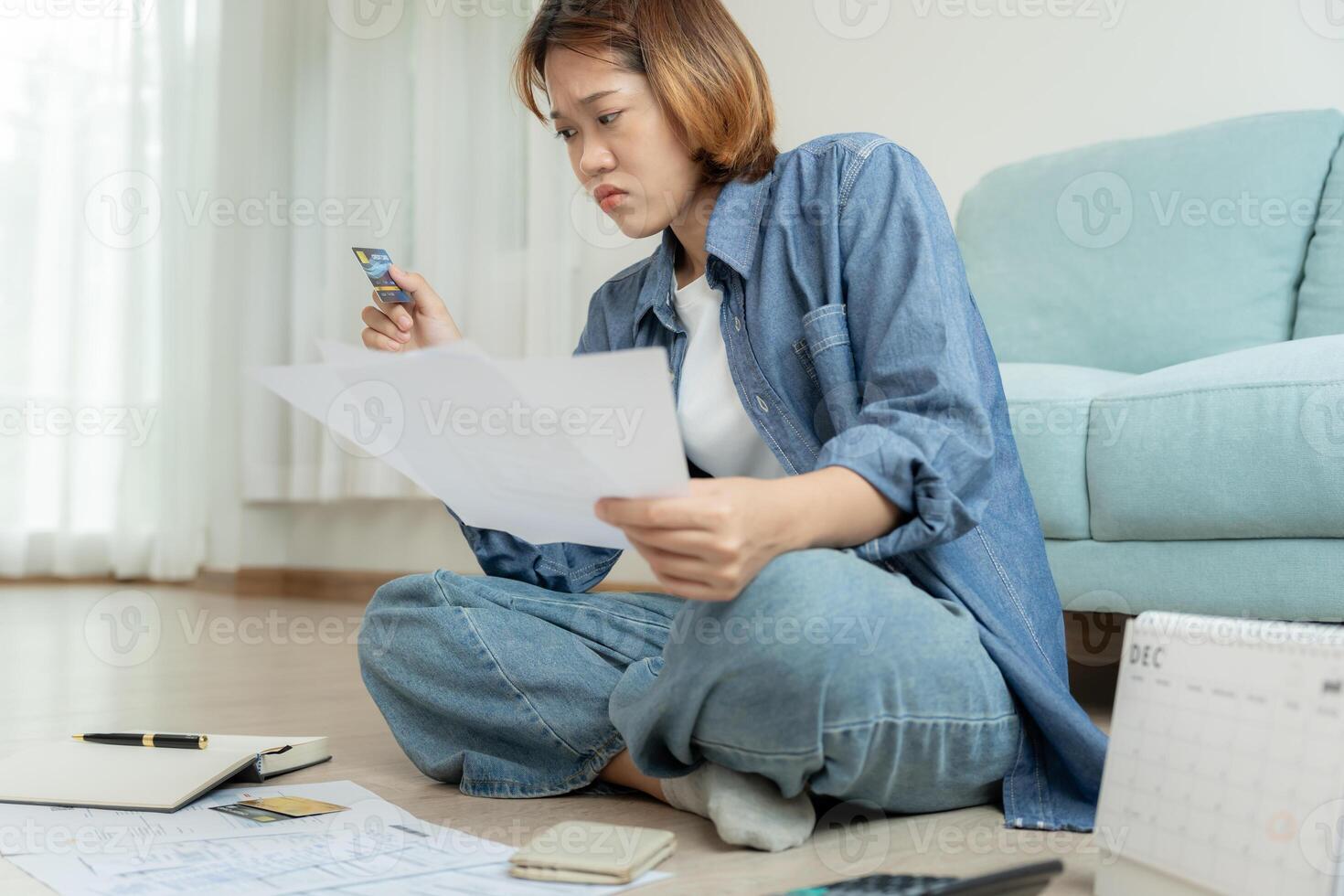 Stressed and headache asian woman with large bills or invoices no money to pay to expenses and credit card debt. shortage, Financial problems, mortgage, loan, bankruptcy, bankrupt, poor, empty wallet. photo