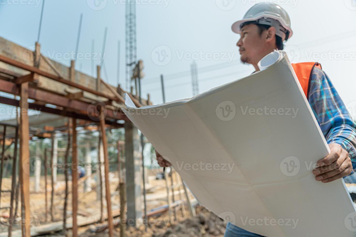 engineer is inspecting construction and quality assurance new house using a blue print. Engineer or architects or contactor work to build the house before handing it over to the homeowner, photo