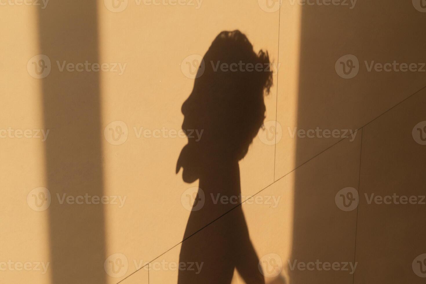 Shadow of a little girl's head on a wall for illustration and concepts, beauty photo