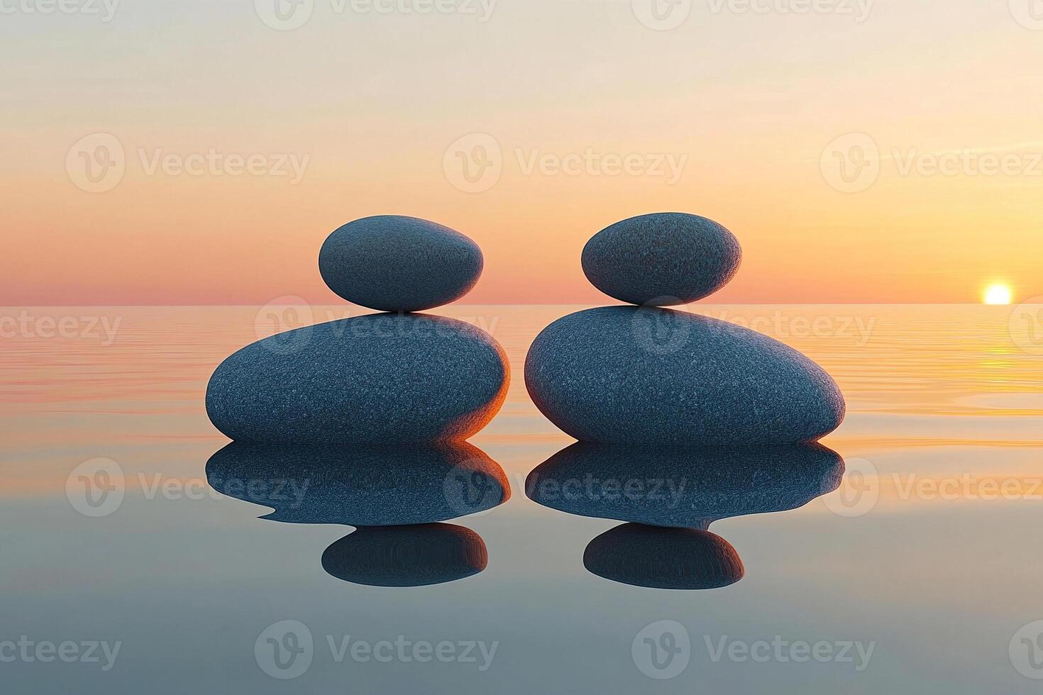 Two pyramids of smooth stones jut out of the calm sea water at sunset. Concept of romance and tranquility. photo