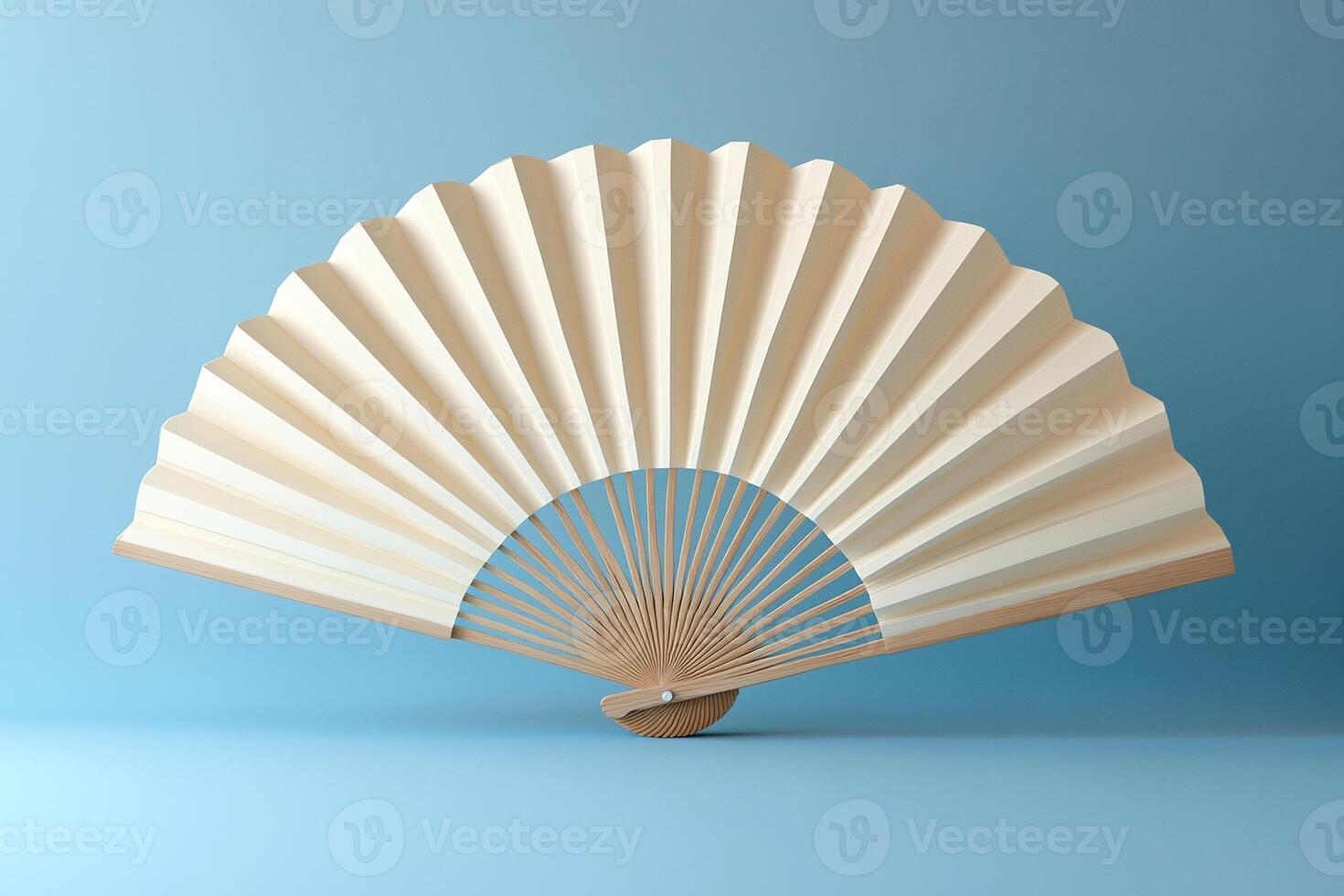 Open white fan with wooden base on blue background. photo