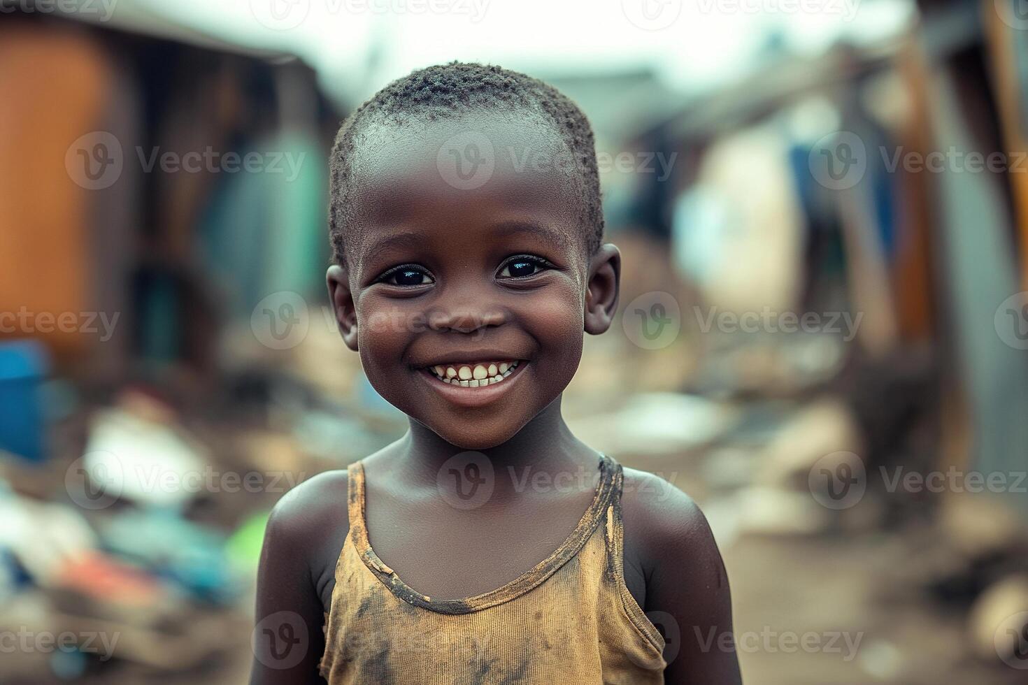 Happy African child on street with slums in background. Concept of helping African children, Children's Day. photo