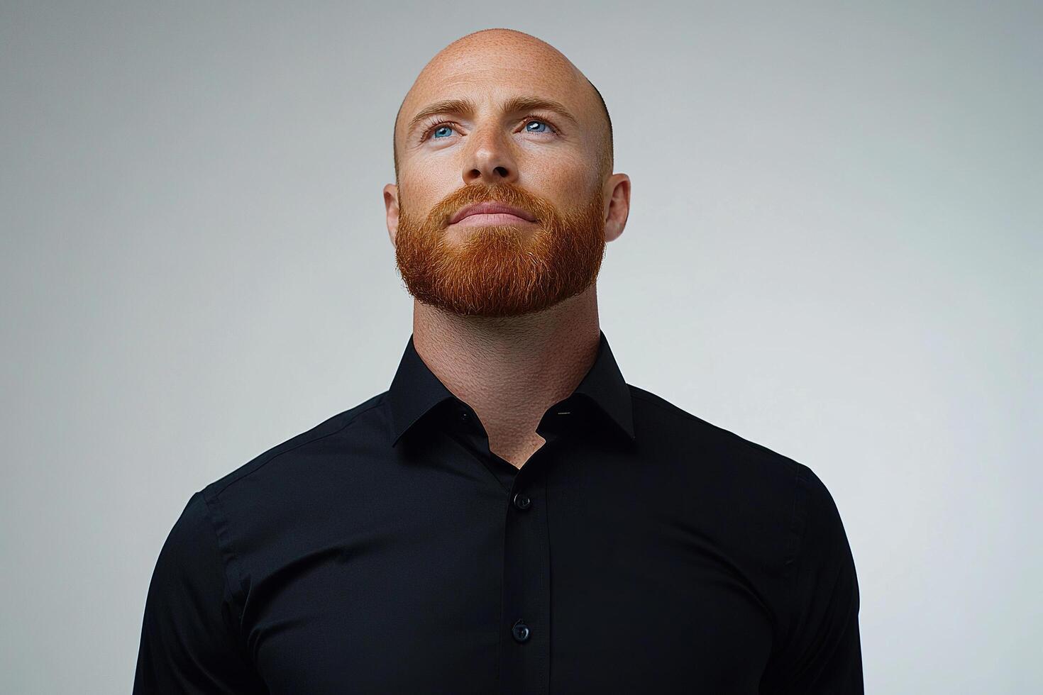 Portrait of young bald businessman in black shirt looking up on white background. Generated by artificial intelligence photo