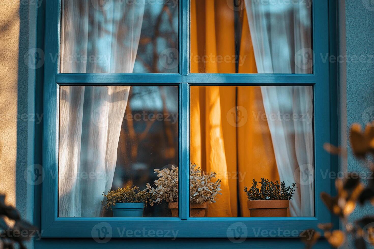 View from outside of a cozy house window with potted plants on the windowsill and curtains. photo