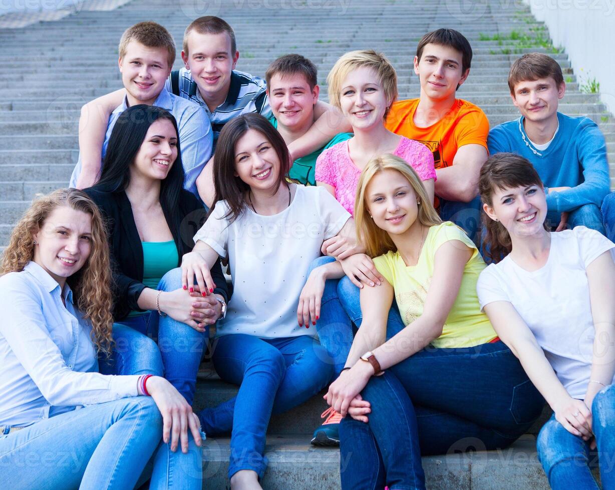 Group of smiling teenagers outdoors photo