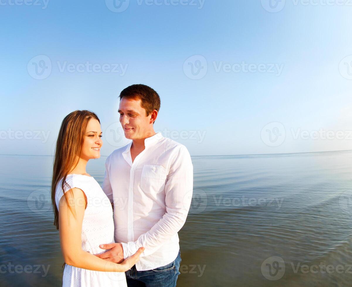 Young happy couple in love by the sea photo