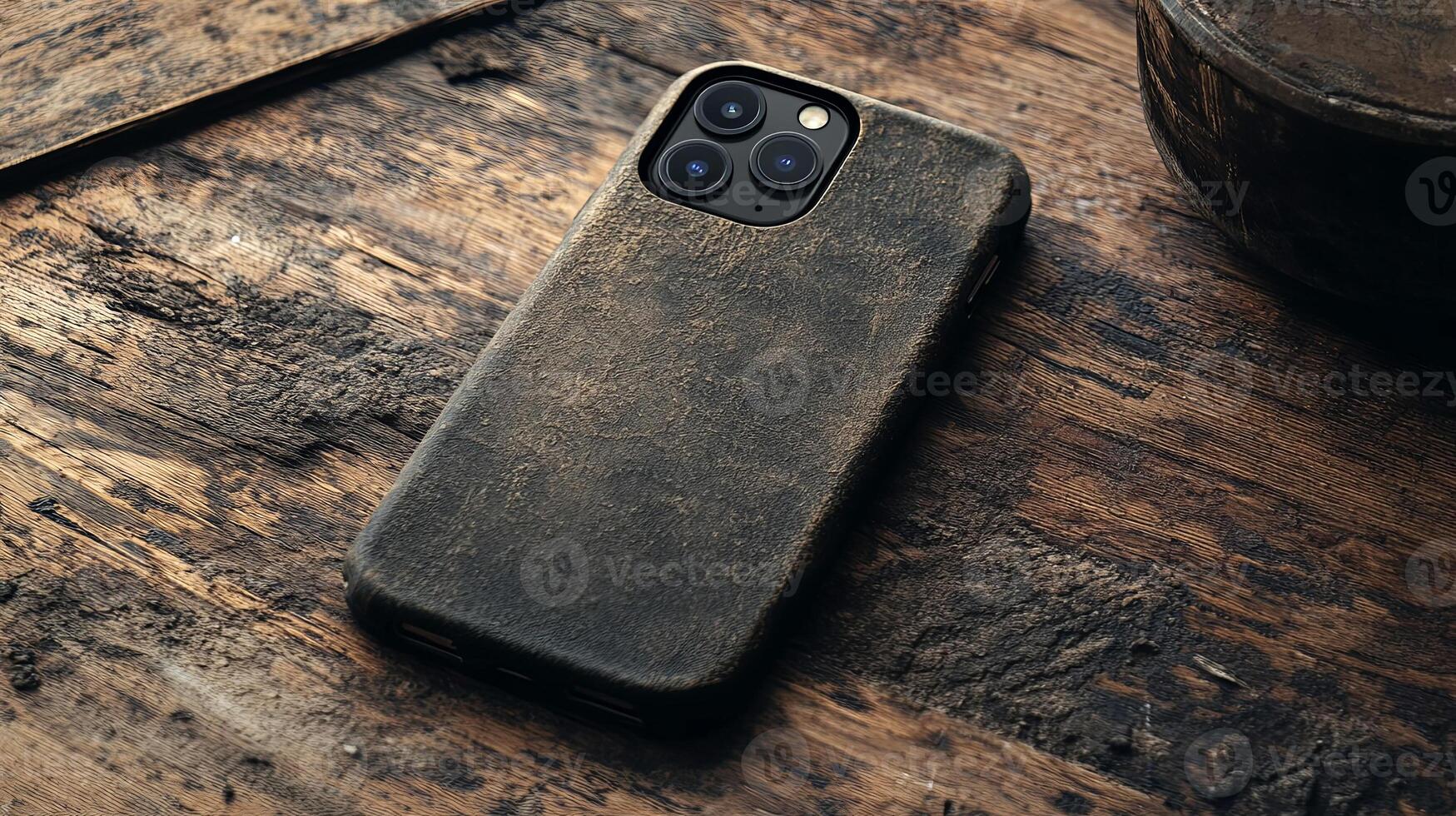 Sleek smartphone with a rugged leather case resting on rustic wood, perfect blend of technology and style photo