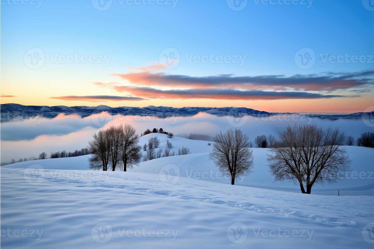 Serene snowy landscape with bare trees and vibrant sunrise above rolling hills and clouds photo