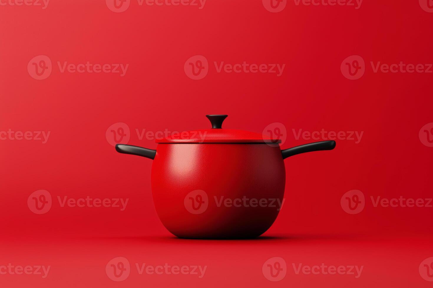 Minimalist red cooking pot with black handles on a vibrant red background photo