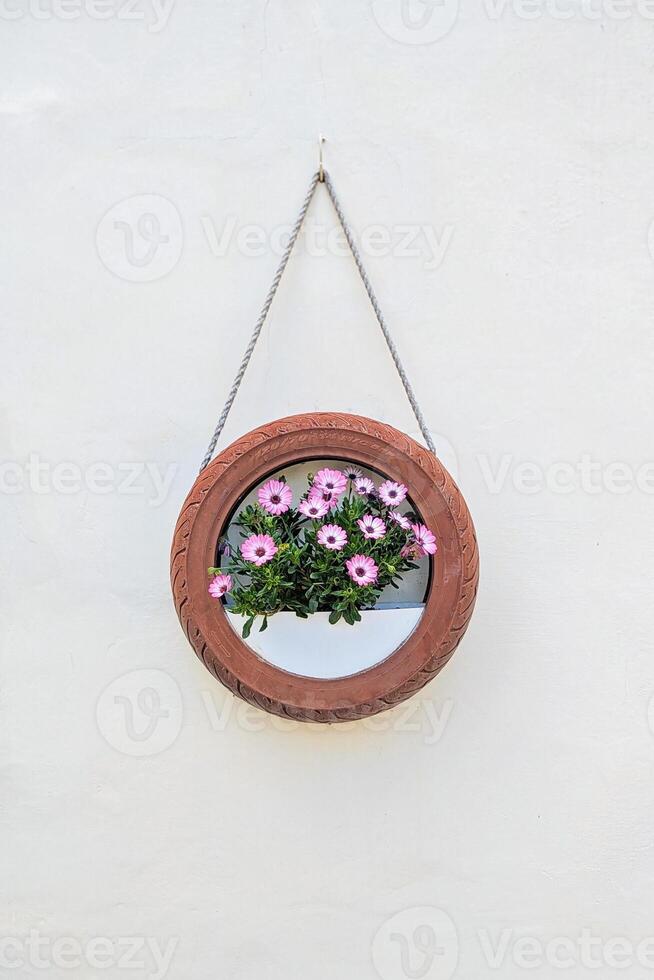 Upcycled tire turned into charming flower holder, highlighting reuse for eco minded households, reuse that blends style with minimal waste, reuse ensuring color and planet care photo