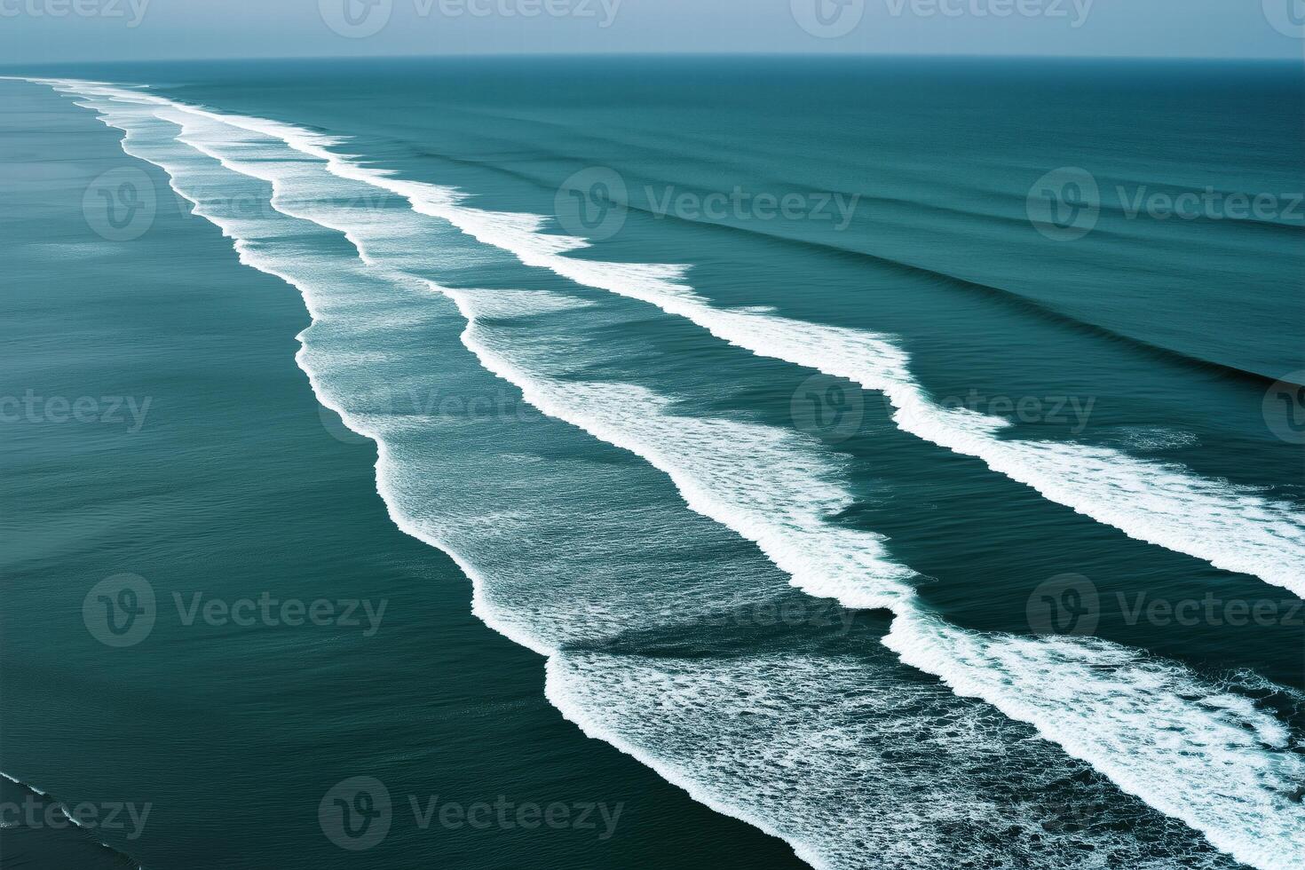 Aerial view of perfectly aligned ocean waves flowing towards shore photo