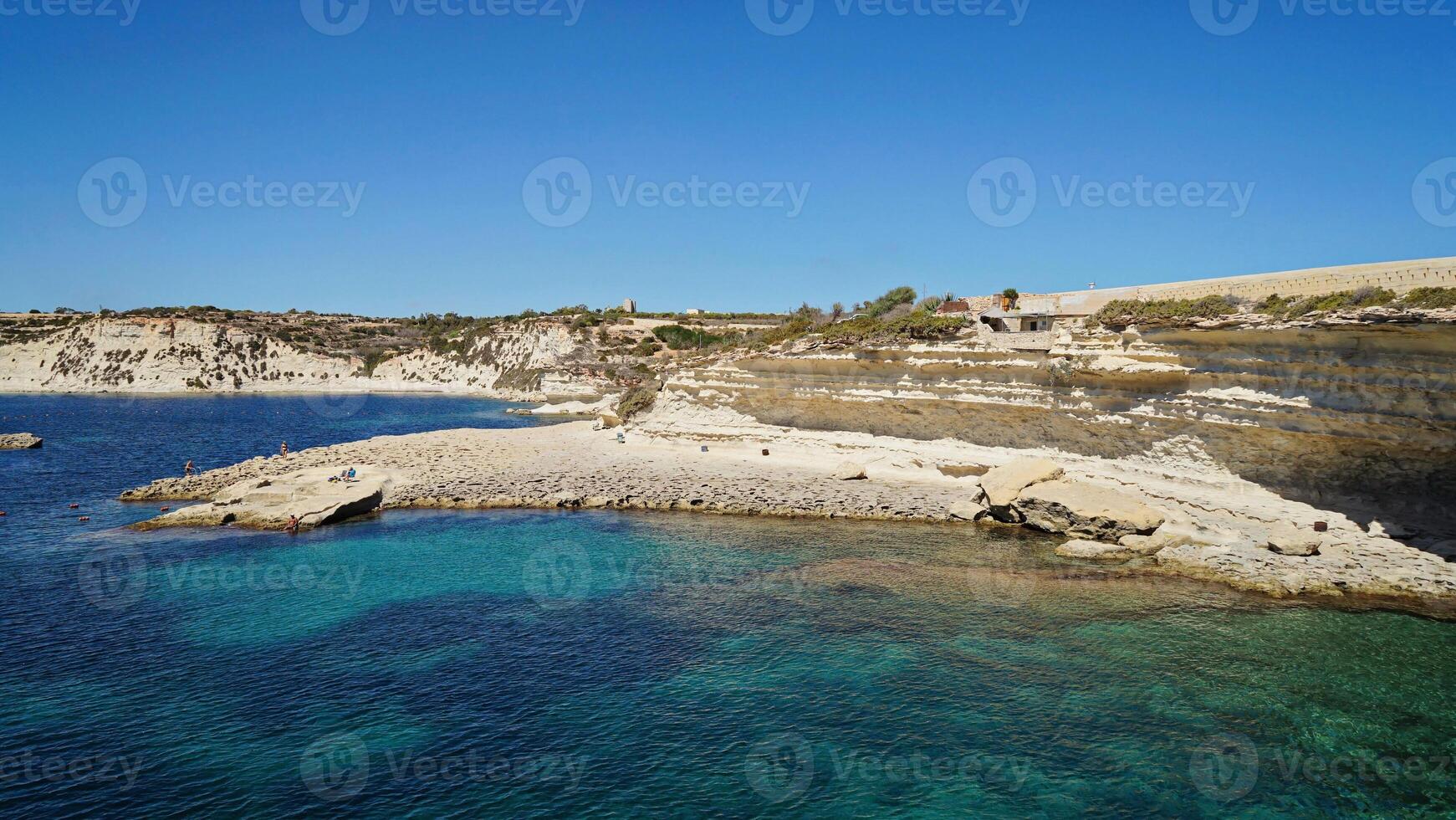 Island vantage reveals rugged Maltese shore, island atmosphere boosting scenic joy photo