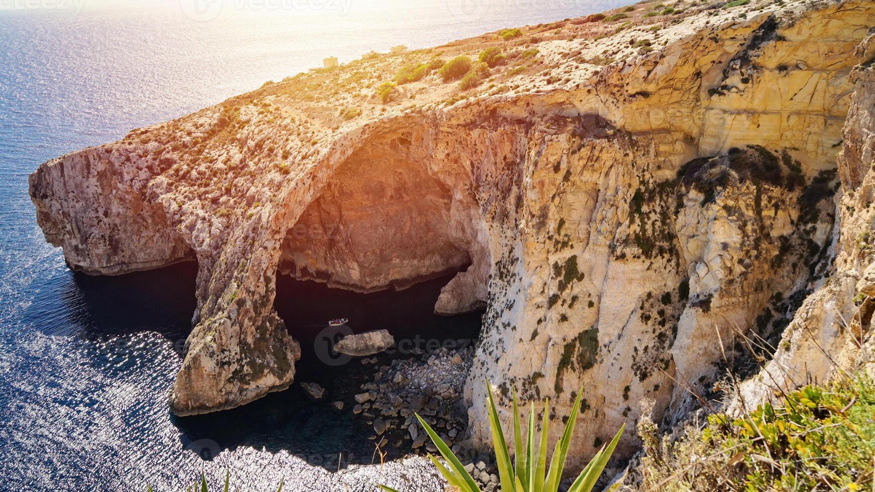 Blue Grotto Malta with Sunlit Cliffs and Deep Blue Sea photo