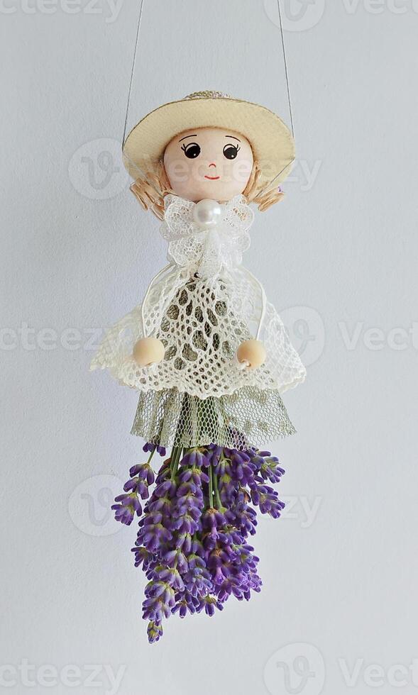 Handmade lavender fragrant doll in cozy rustic decor on white photo