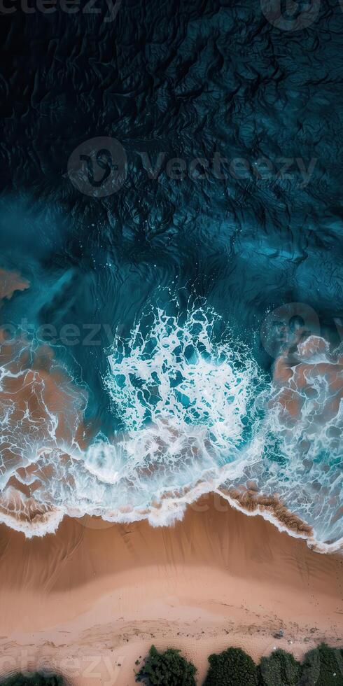 Aerial View of Ocean Waves Crashing on Sandy Beach, Perfect for Coastal, Nature, and Travel Photography Projects photo