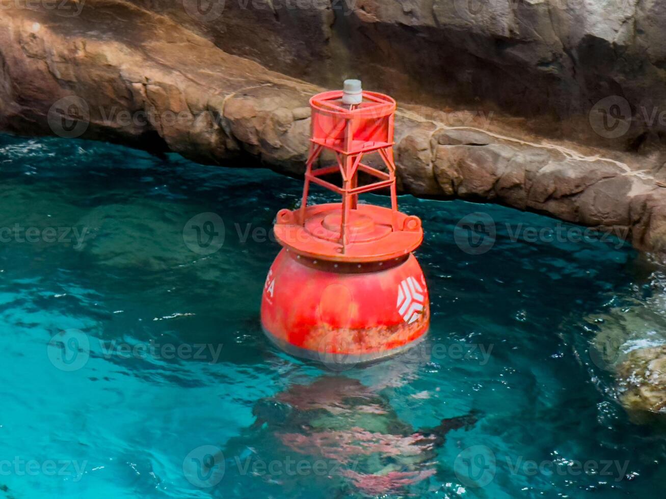 sea floating signal, such as a buoy, bobbing gently on the water's surface, for maritime safety photo