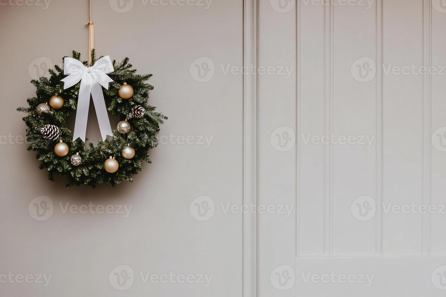 A wreath with gold balls hanging on a door photo