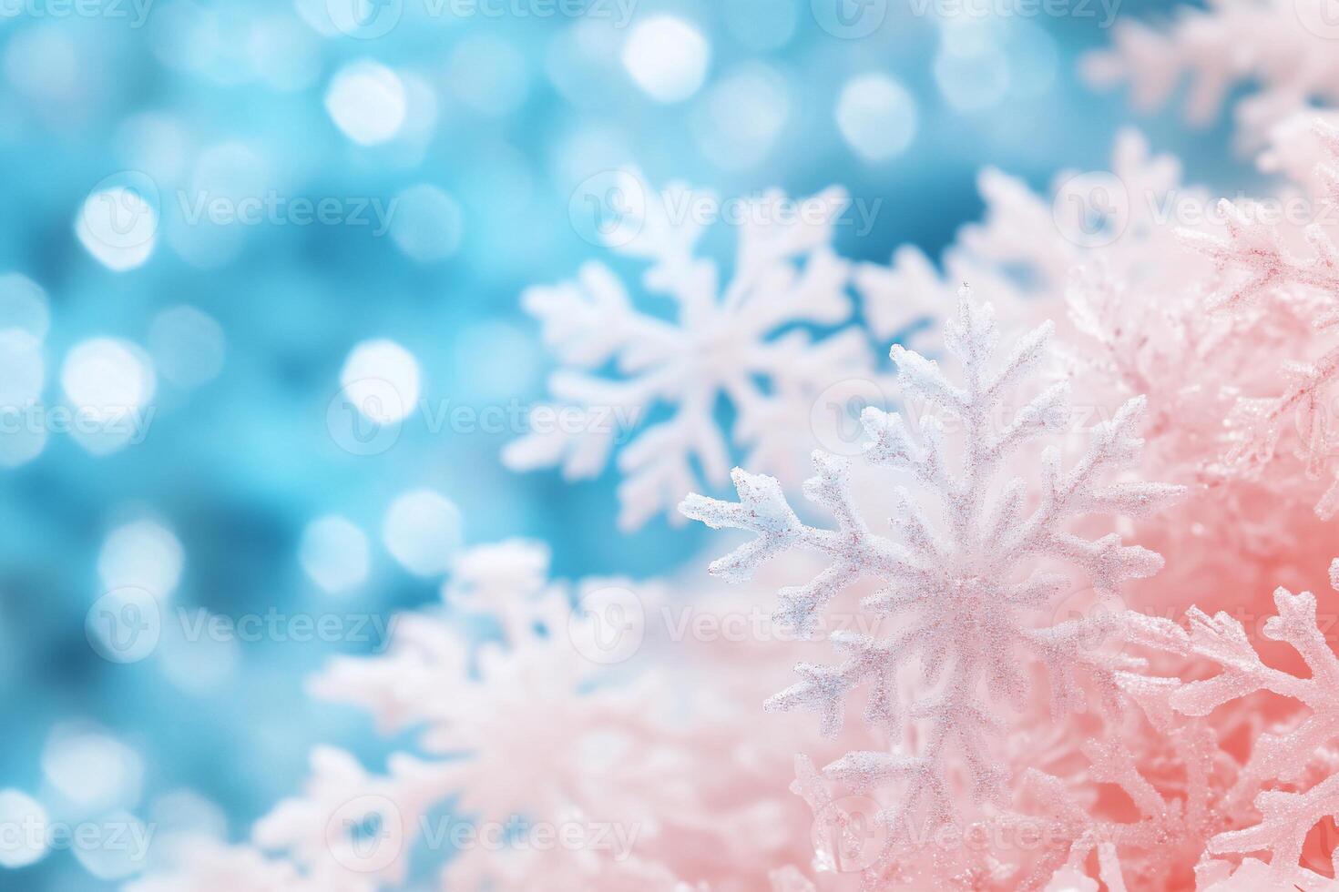 A close-up of snowflakes on a soft blue and pink background. photo