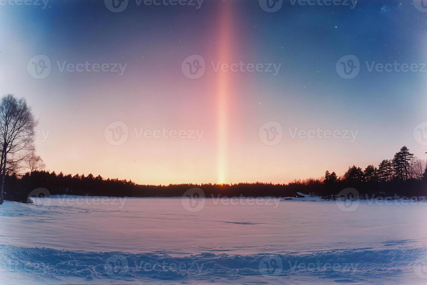 A serene winter landscape with a vibrant sunrise over a snowy lake. photo