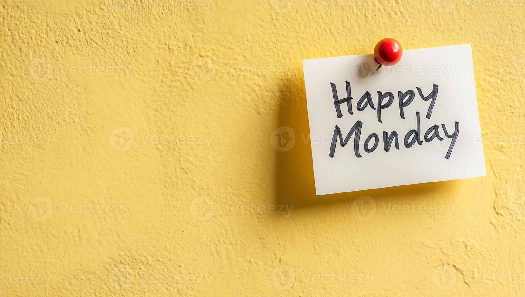 Happy monday written on a sticky note on a yellow wall photo