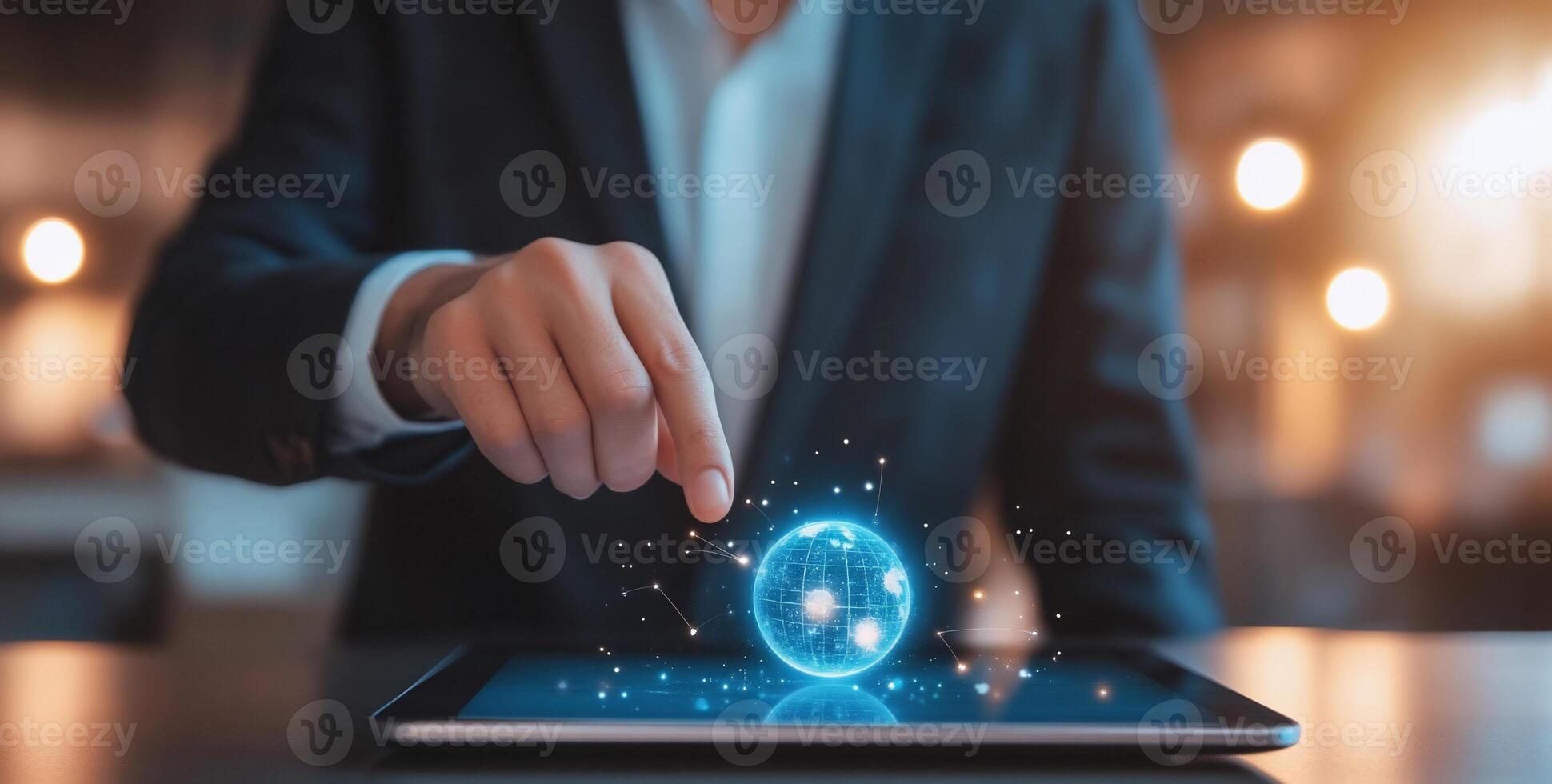 A businessperson interacts with a holographic globe on a tablet. photo