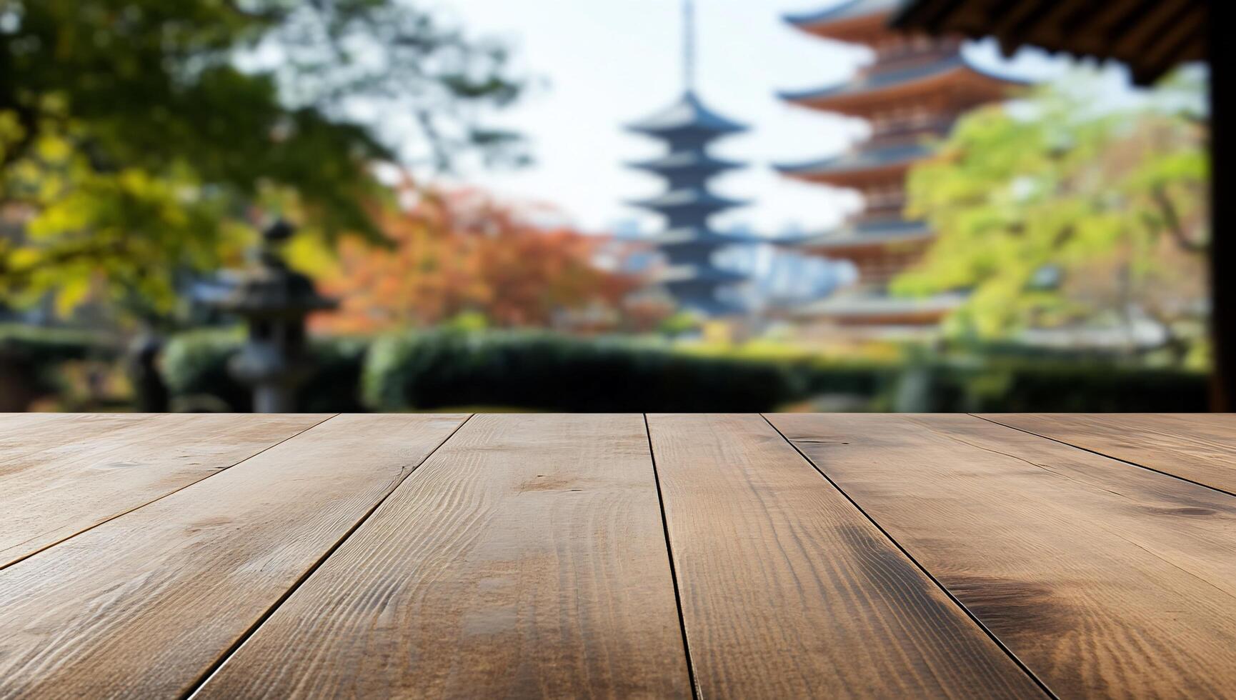A blurred background of pagodas with a wooden table in the foreground. photo