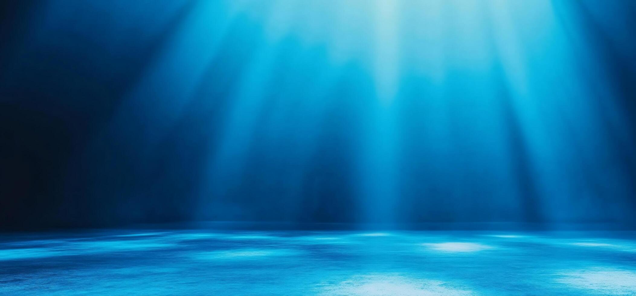 A serene underwater scene illuminated by soft blue light beams. photo