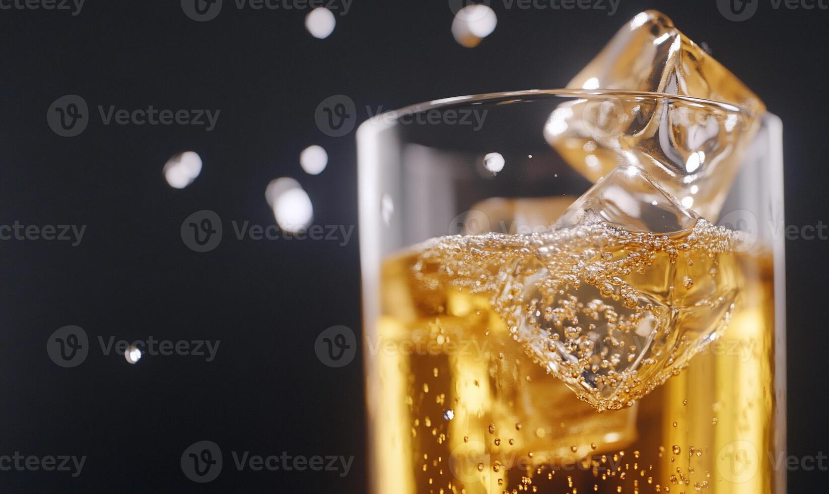 A close-up of a fizzy drink with ice cubes and bubbles. photo