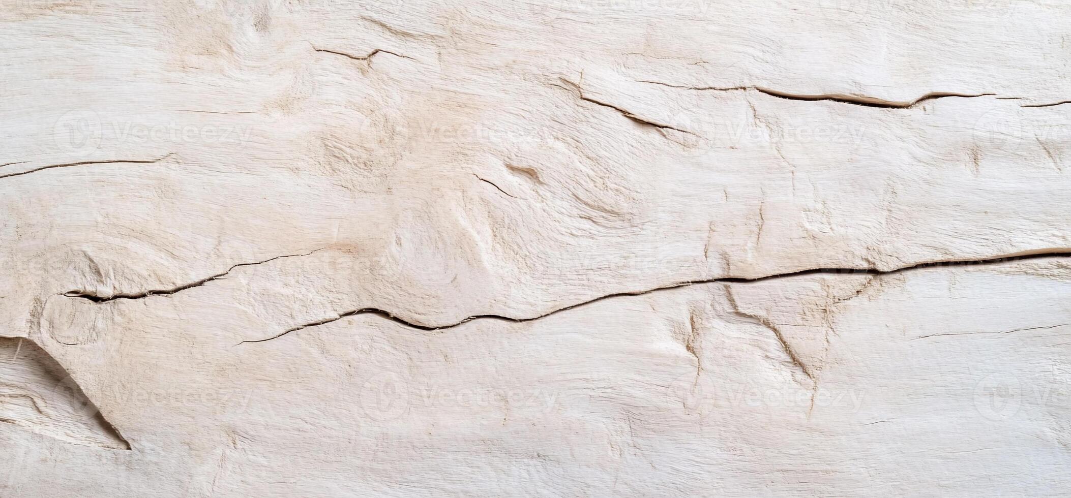 A close-up of a textured wooden surface with visible cracks. photo
