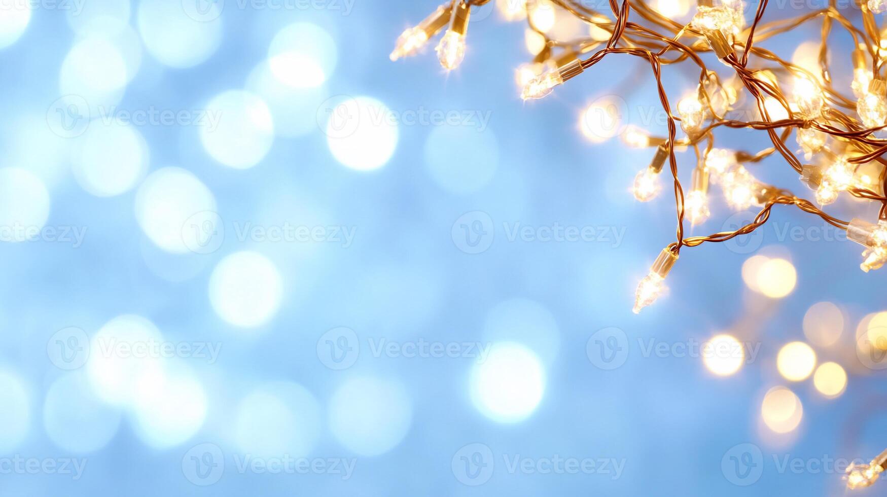 A close-up of glowing fairy lights against a soft blue background. photo